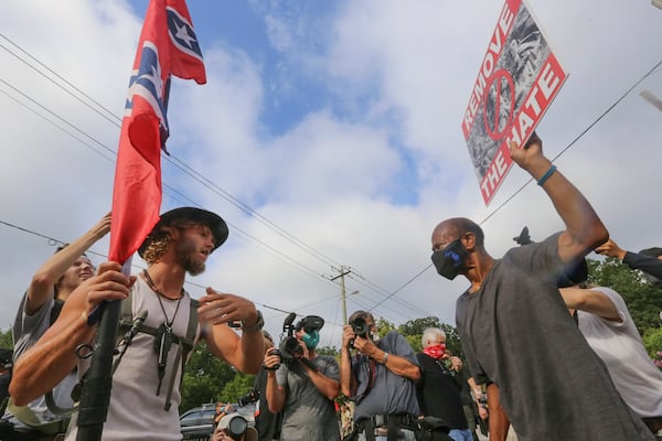 8/15/20 - Stone Mountain, GA - Protestors and counter protestors face off in the town of Stone Mountain after Stone Mountain Park was closed.  Several far-right groups, including militias and white supremacists, were planning to rally Saturday at Stone Mountain, and a broad coalition of leftist anti-racist groups are organizing a counter-demonstration. Local authorities, who have been closely monitoring online chatter about the rally, are bracing for possible conflict.   Jenni Girtman for the Atlanta Journal Constitution