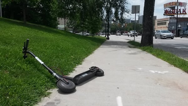 Motorized scooters and other rental electric mini transportation devices are sweeping through intown Atlanta. Most aren’t required to be dropped off at centralized docks. So some riders dump them wherever their ride ends, including on city sidewalks, like this Bird scooter left along Ponce De Leon Avenue. MATT KEMPNER / AJC