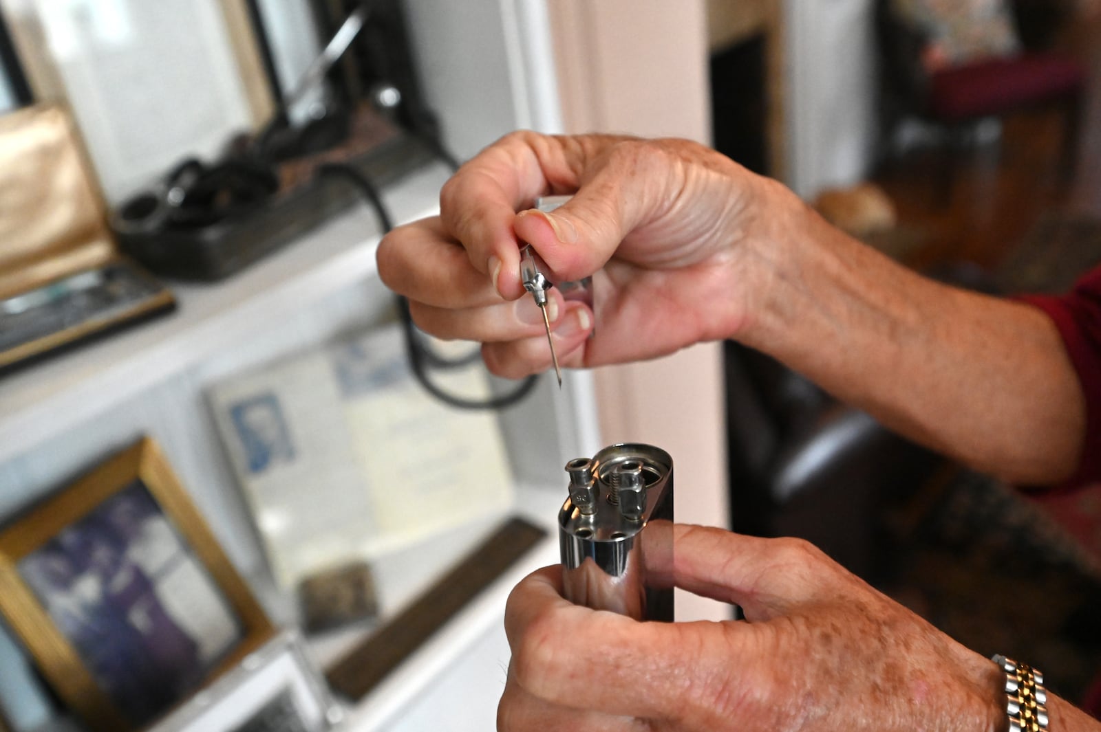 Patricia Goodman demonstrates an old item of medical equipment from her collection of memorabilia of her grandfather Dr. Job Caldwell Patterson. (Hyosub Shin / Hyosub.Shin@ajc.com)