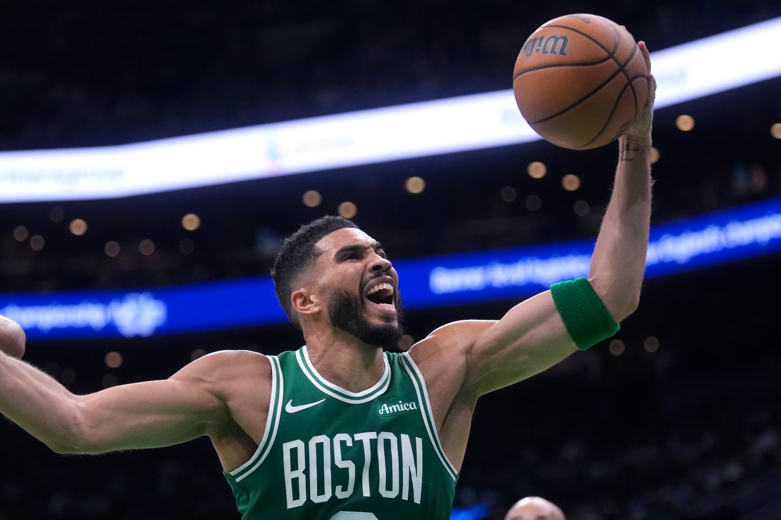 Boston Celtics forward Jayson Tatum grabs a rebound against the New York Knicks during the first half of an NBA basketball game, Tuesday, Oct. 22, 2024, in Boston. (AP Photo/Charles Krupa)