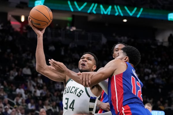 Detroit Pistons' Tobias Harris fouls Milwaukee Bucks' Giannis Antetokounmpo during the second half of an NBA basketball game Wednesday, Nov. 13, 2024, in Milwaukee. (AP Photo/Morry Gash)