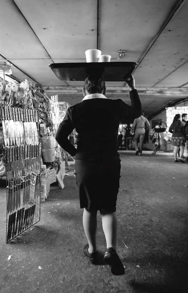 A waitress delivers soup from a fonda at Mexico City’s Central de Abastos market. Courtesy of Ten Speed Press/James Roper © 2020