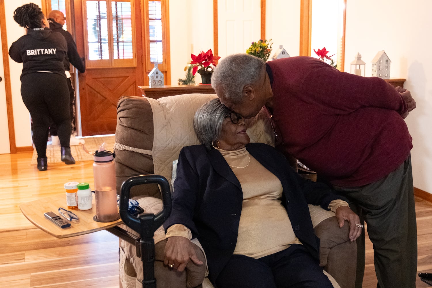 John Coleman, 82, kisses his 102-year-old mother Lillie Mae Hightower on the forehead during her birthday celebration in Stockbridge on Friday, Dec. 27, 2024.   Ben Gray for the Atlanta Journal-Constitution