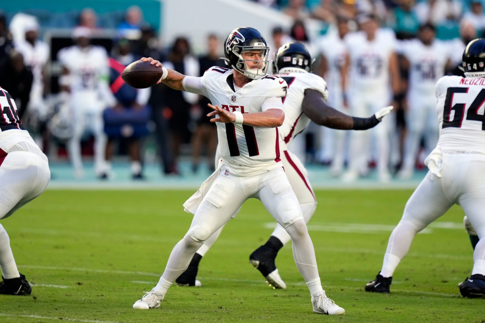 Atlanta Falcons quarterback Logan Woodside (11) throws a pass during the first half of a preseason NFL football game against the Miami Dolphins, Friday, Aug. 11, 2023, in Miami Gardens, Fla. (AP Photo/Wilfredo Lee)