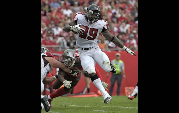 Atlanta Falcons running back Steven Jackson (39) eludes Tampa Bay Buccaneers free safety Bradley McDougald (30) to score on a 1-yard touchdown run during the first quarter of an NFL football game Sunday, Nov. 9, 2014, in Tampa, Fla. (AP Photo/Phelan Ebenhack)