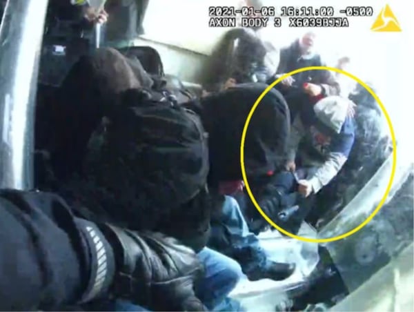 In a still photo captured from police body cameras, a man investigators say is Douglas County resident Phillip Marion "Bunky" Crawford Jr. is seen grabbing a fallen police officer during fighting on Jan. 6, 2021, at the U.S. Capitol.