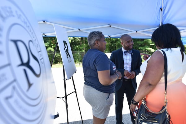 Davion Lewis (center), talks with guests during the RISE Schools groundbreaking ceremony at the school formerly called Latin Grammar School and Latin College Preparatory School in East Point on Friday, June 29, 2018. HYOSUB SHIN / HSHIN@AJC.COM