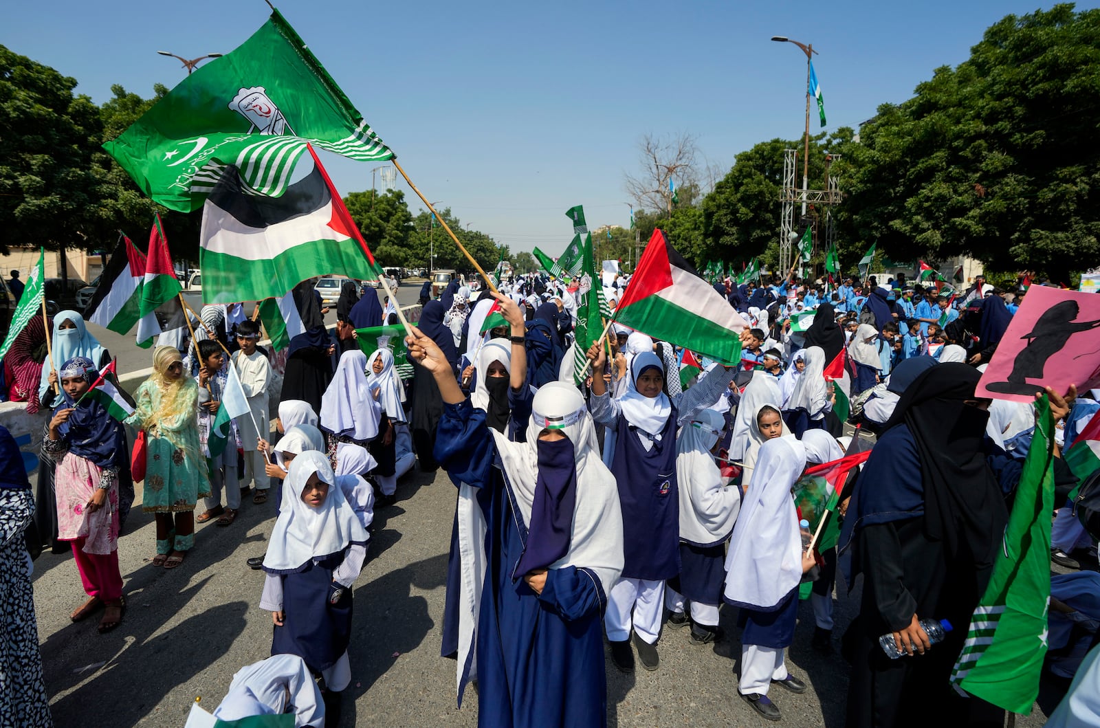 School children take part in a rally organized by Pakistan Markazi Muslim League party, to protest against Israeli airstrikes and to show solidarity with Palestinian people living in Gaza and Lebanon, in Karachi, Pakistan, Monday, Oct. 7, 2024. (AP Photo/Fareed Khan)