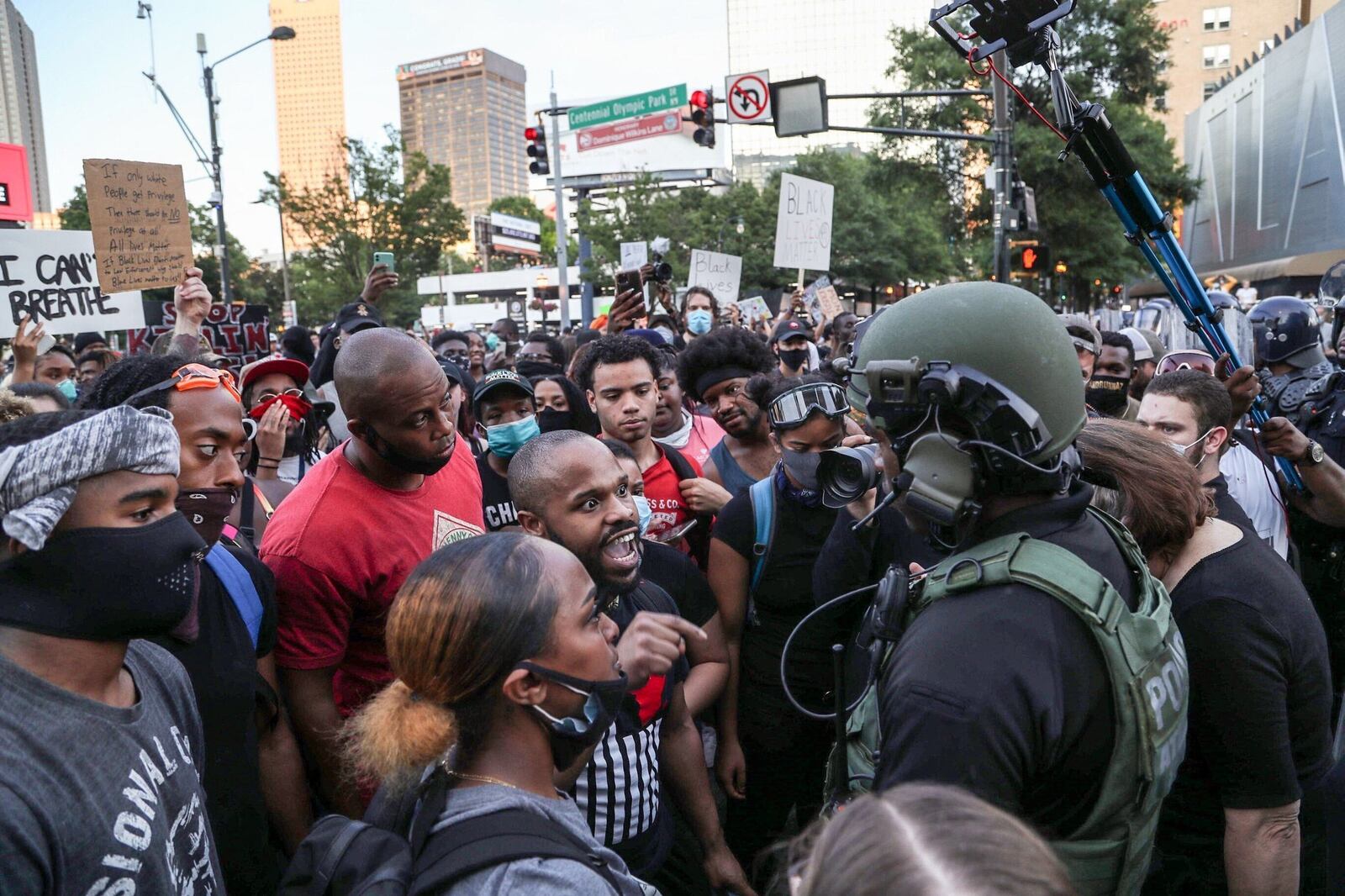 June 1, 2020 -  Atlanta -  Protesters exchange words with police officers in front of the CNN Center.  Protestors were active downtown as protests continued for a fourth day.  Protests over the death of George Floyd in Minneapolis police custody continued around the United States, as his case renewed anger about others involving African Americans, police and race relations.     Alyssa Pointer / alyssa.pointer@ajc.com