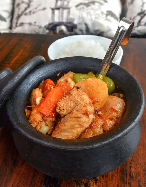 Afritada, a Filipino dish of a whole chicken cut up with potatoes, peppers, tomatoes, garlic and onion, is shown here over jasmine rice at Estrellita restaurant in Grant Park. Styling by Walter Cortado and Blesseda Gamble / Chris Hunt for The Atlanta Journal-Constitution