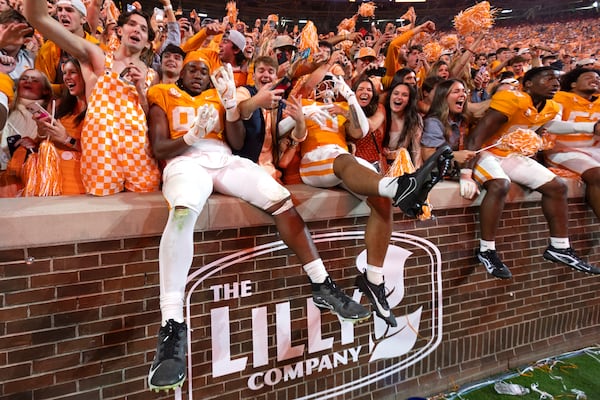 FILE - Tennessee tight end Titus Rohrer (89) and tight end Ethan Davis (0) celebrate with fans after an NCAA college football game against Alabama, Saturday, Oct. 19, 2024, in Knoxville, Tenn. (AP Photo/Wade Payne, File)