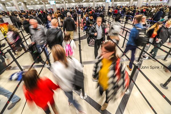 Travelers made their way Friday morning through the security checkpoint at Hartsfield-Jackson International Airport.