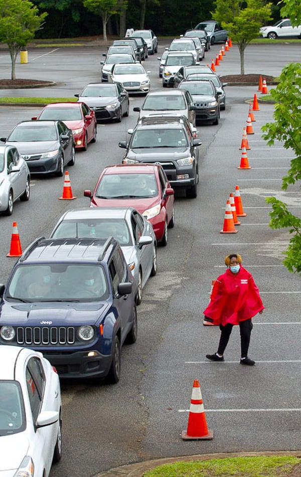 Cars line up Wednesday at the COVID-19 testing center at Greenforest Community Baptist Church in Decatur. 