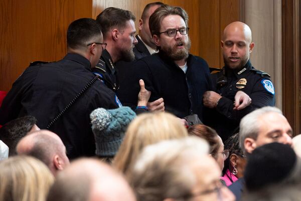 A protester is removed while calling out against the nomination of Linda McMahon, President Donald Trump's nominee for Secretary of Education, during a Senate Health, Education and Labor Committee hearing on Thursday, Feb. 13, 2025, in Washington. (Jacquelyn Martin/AP)