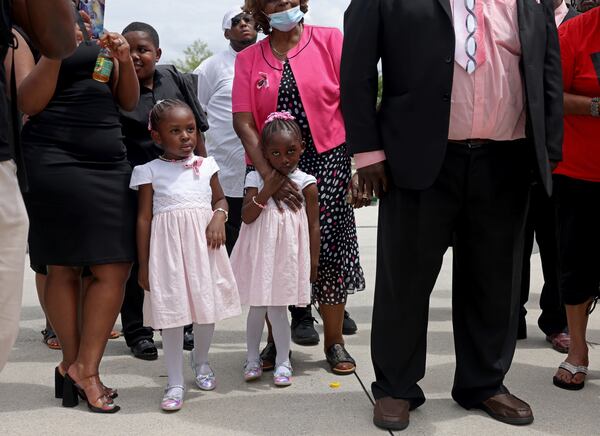 081122 Atlanta, Ga.: The three-year-old twin girls of the late Brianna Grier listen during a gathering to demand action for the late Brianna Grier at Liberty Plaza across the street from the State Capitol, Thursday, August 11, 2022, in Atlanta. Grier is the woman who died after Hancock Police officers left the door open on the back of the police car after arresting her. (Jason Getz / Jason.Getz@ajc.com)