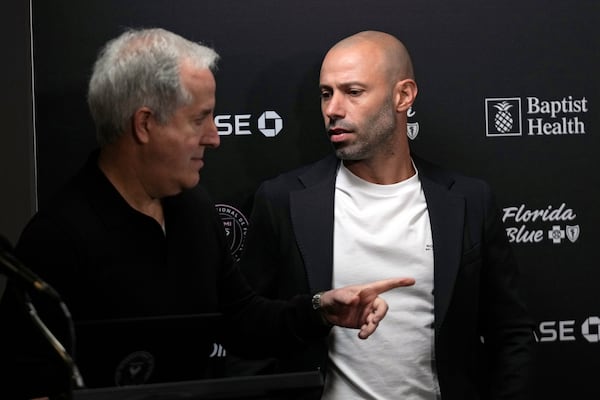 Inter Miami's managing owner and CEO Jorge Mas, left, talks with new head coach Javier Mascherano before introducing him at an MLS soccer news conference, Tuesday, Dec. 3, 2024, in Fort Lauderdale, Fla. (AP Photo/Wilfredo Lee)