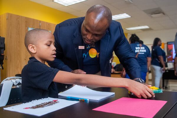 Superintendent Bryan Johnson (right) interacts with 11-year-old student Ronnie Burks at the Sylvan Hills Middle School’s first day of class in Atlanta on Thursday, Aug. 1, 2024.  (Ziyu Julian Zhu / AJC)