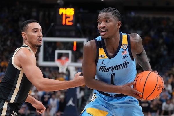 Marquette's Kam Jones tries to get past Purdue's Trey Kaufman-Renn during the first half of an NCAA college basketball game Tuesday, Nov. 19, 2024, in Milwaukee. (AP Photo/Morry Gash)