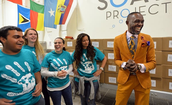 Derreck Kayongo (right) met last year with university student volunteers at the Global Soap Project, which Kayongo co-founded. The organization recycles the little hotel soaps that Americans use and then throw away. Kayongo was recently named as the new CEO of another organization, the Atlanta-based National Center for Civil and Human Rights. HYOSUB SHIN / HSHIN@AJC.COM