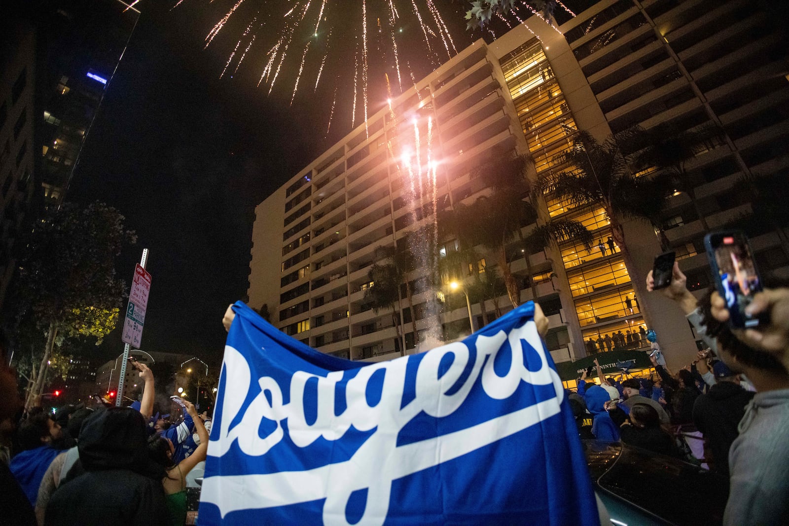 Fireworks go off as fans celebrate on the streets after the Los Angeles Dodgers defeated the New York Yankees to win the baseball World Series Wednesday, Oct. 30, 2024, in Los Angeles. (AP Photo/Ethan Swope)