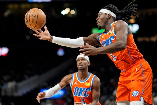 Oklahoma City Thunder guard Luguentz Dort (5) chases a rebound against the Atlanta Hawks during the first half of an NBA basketball game, Friday, Feb. 28, 2025, in Atlanta. (AP Photo/Mike Stewart)