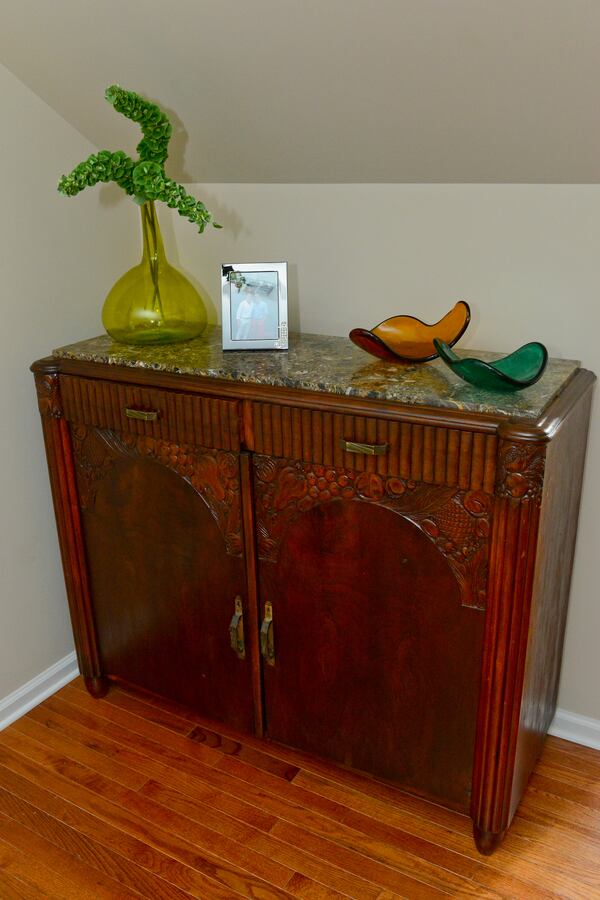 Homeowners Jeffrey Chandler and Pedro Ayestaran Diaz enjoy looking for furniture to decorate their Vinings townhome. They found this 1920s French cabinet at an estate sale in Buckhead. Text by Lori Johnston and Keith Still/Fast Copy News Service. (Christopher Oquendo Photography/www.ophotography.com)