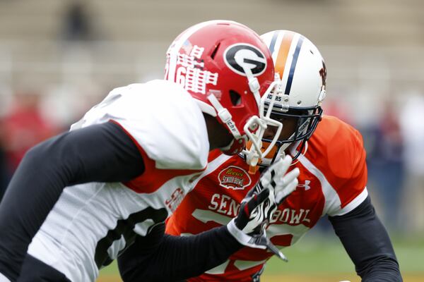 Auburn's Jonathan Jones #23 runs through drills against Georgia wide receiver Malcolm Mitchell for the South during NCAA college football practice for the Senior Bowl, Tuesday, Jan. 26, 2016, at Fairhope Municipal Stadium, in Fairhope, Ala.(AP Photo/Brynn Anderson)