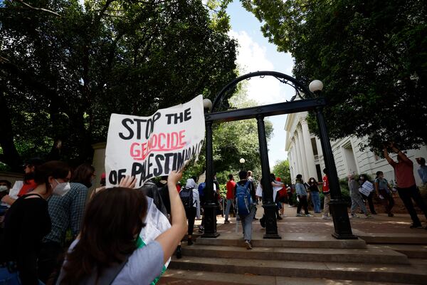 Dozens of Pro-Palestinian protesters chant as they cross the University Arch at UGA campus in Athens following arrests on Monday, April 29, 2024.
(Miguel Martinez / AJC)