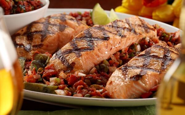 The salsa Veracurzana goes perfectly with grilled fish, like this salmon. (Michael Tercha/Chicago Tribune/TNS)