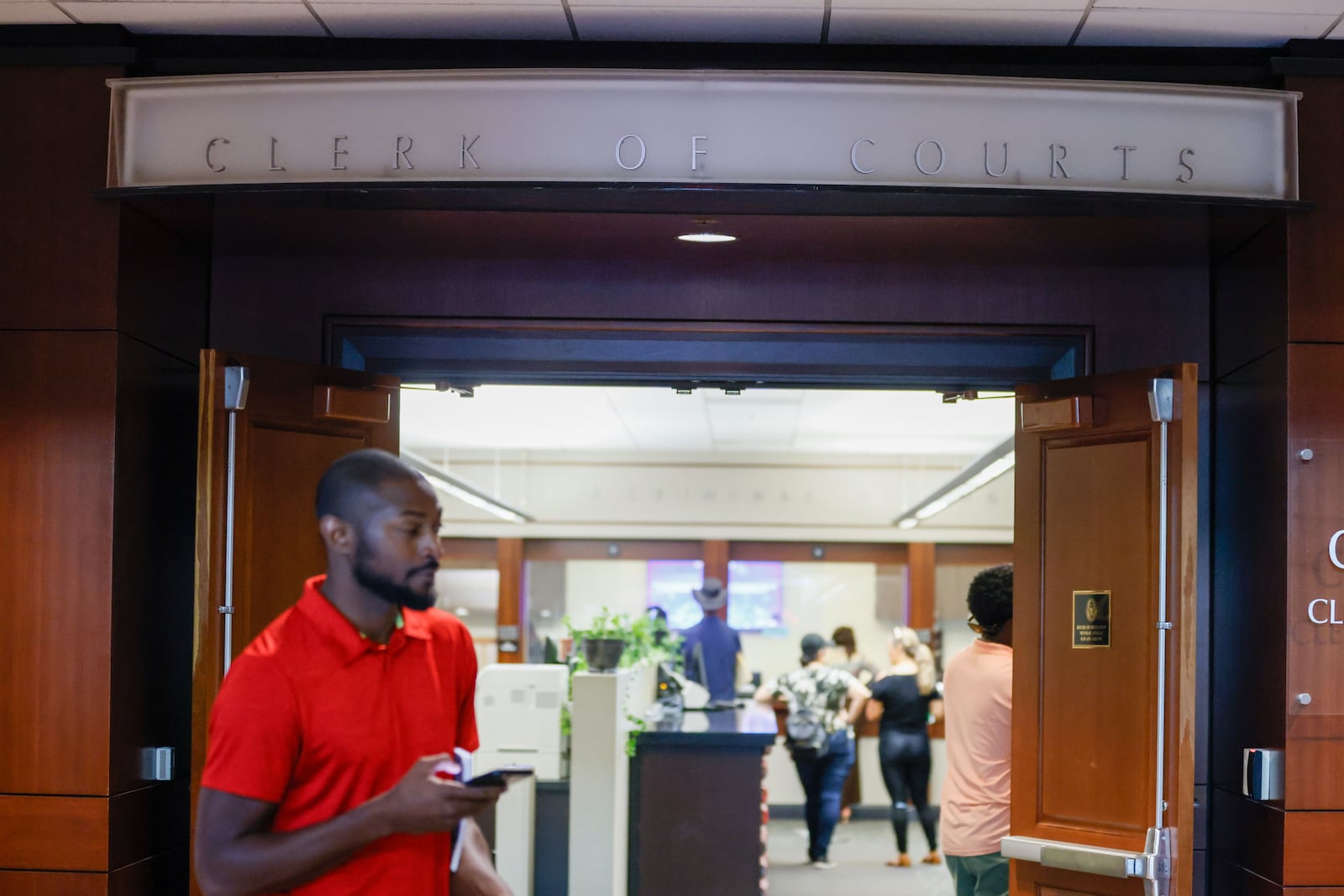 People are seen completing administrative paperwork at the clerk’s office windows in the Cobb County Superior Court on Thursday, August 8, 2024.
(Miguel Martinez / AJC)