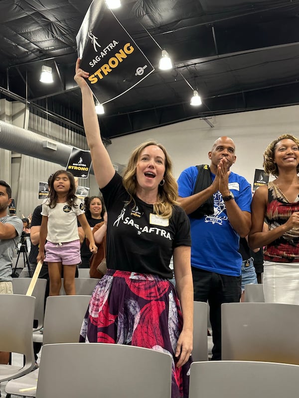 Bethany Lind, a SAG-AFTRA actress who worked on Netflix's "Ozark," cheers on the speakers at a strike rally at the Teamsters Local Union 728 building in Atlanta August 22, 203. RODNEY HO/rho@ajc.com