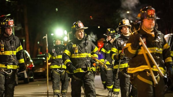 Firefighters leave after putting out a major house fire in the Bronx borough of New York City.