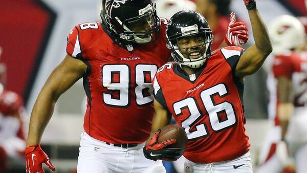 alcons cornerback Josh Wilson, right, celebrates intercepting Cardinals Drew Stanton with teammate Cliff Matthews during the second half in an NFL football game on Sunday, Nov. 30, 2014, in Atlanta. The Falcons beat the Cardinals 29-18. (AP Photo/Atlanta Journal-Constitution, Curtis Compton)