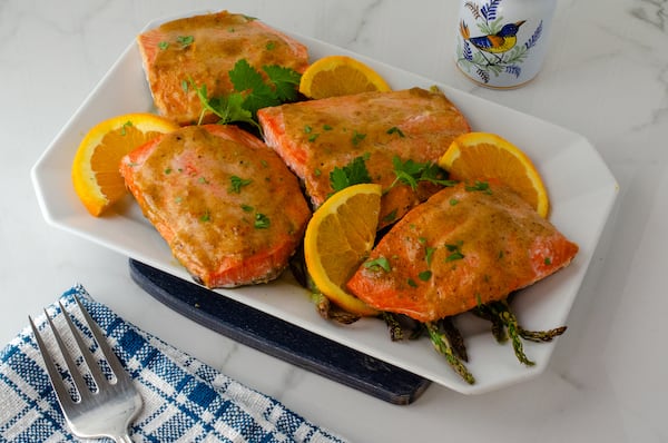 You don't have to worry about thawing frozen salmon fillets before making Baked Orange Mustard Salmon with Asparagus. (Virginia Willis for The Atlanta Journal-Constitution)