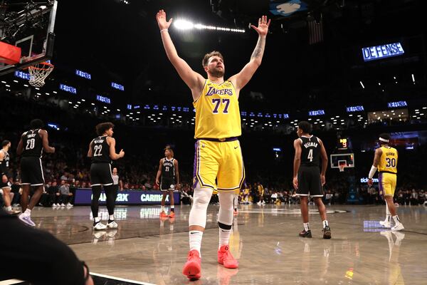 Los Angeles Lakers' Luka Doncic (77) reacts after a foul was called on the Brooklyn Nets during the second half of an NBA basketball game Monday, March 10, 2025, in New York. (AP Photo/Pamela Smith)