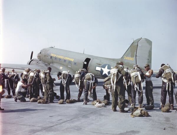 Paratroopers of the 555th Parachute Infantry climb into their parachute harnesses before boarding a plane as part of Operation Firefly in the Umatilla National Forest, Oregon. During the 1945 Firefly mission, the 555th made 1,200 jumps and suppressed 36 fires. (National Archives)