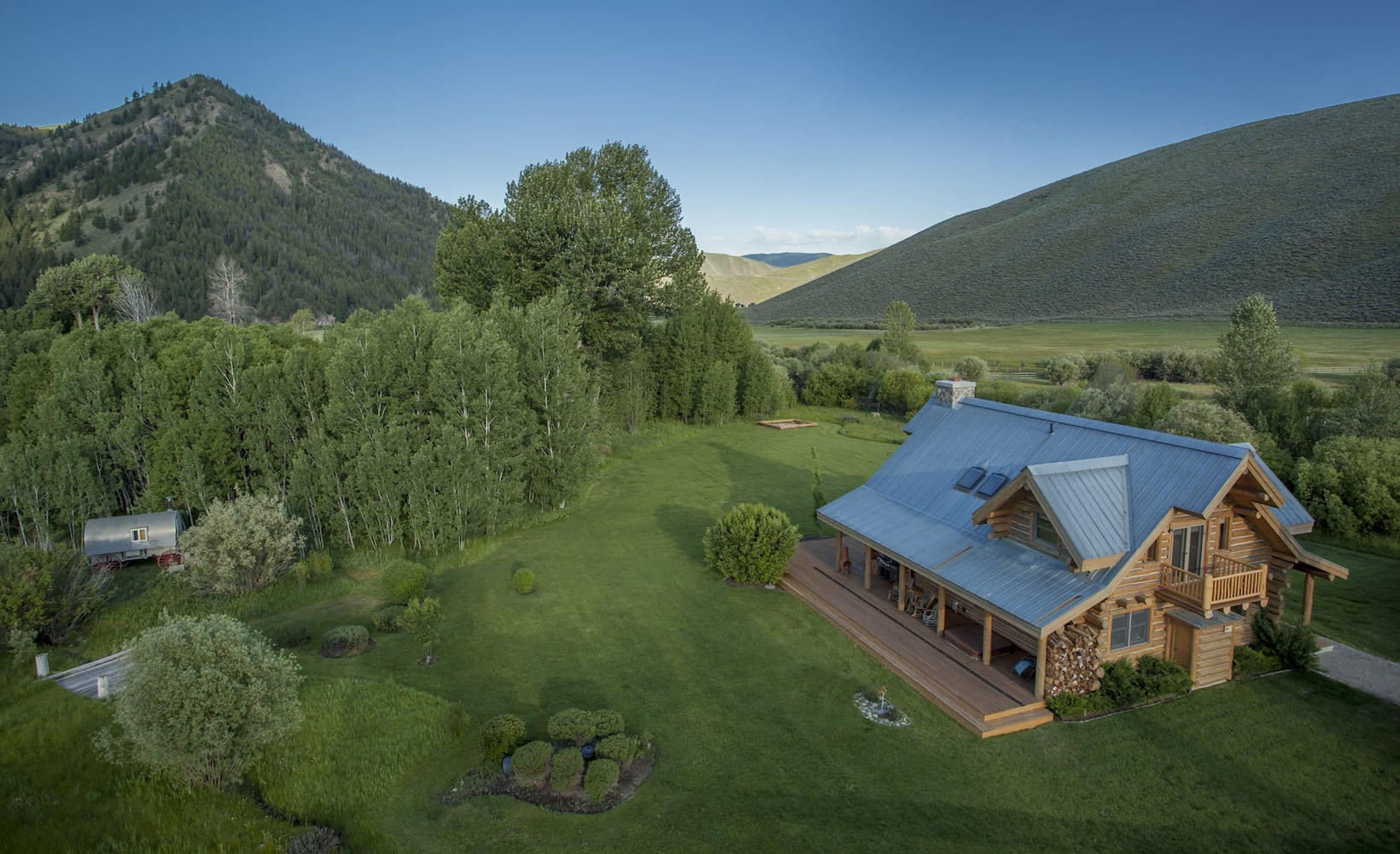 500-acre property has log cabins, mountain views