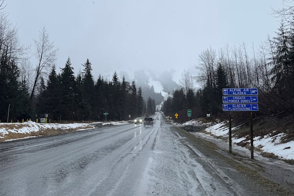 A sign on Alyeska Highway points to winter tourism businesses in Girdwood, Alaska, on Wednesday, March 1, 2025. (AP Photo/Mark Thiessen)