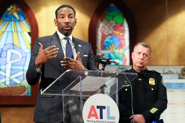 Atlanta Mayor Andre Dickens speaks to members of the media during a press conference next to Atlanta Police Department Chief Darin Schierbaum, right, to discuss reduced crime rate in Atlanta at Salem Bible Church, Thursday, January 4, 2024, in Atlanta. (Jason Getz / Jason.Getz@ajc.com)