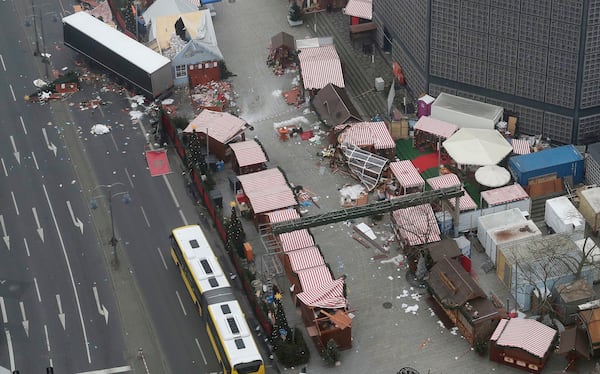 FILE - In this Dec. 20, 2016 file photo the trailer of a truck stands beside destroyed Christmas market huts in Berlin, Germany. (AP Photo/Markus Schreiber, file)