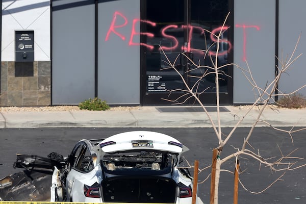 A burned Tesla vehicle is shown at a Tesla collision center Tuesday, March 18, 2025, in Las Vegas. (Steve Marcus/Las Vegas Sun via AP)