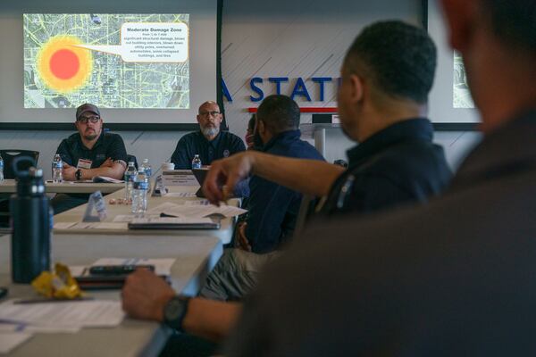 Attendees watch a video describing the immediate aftermath of a nuclear detonation during a tabletop exercise at Georgia State University in March.