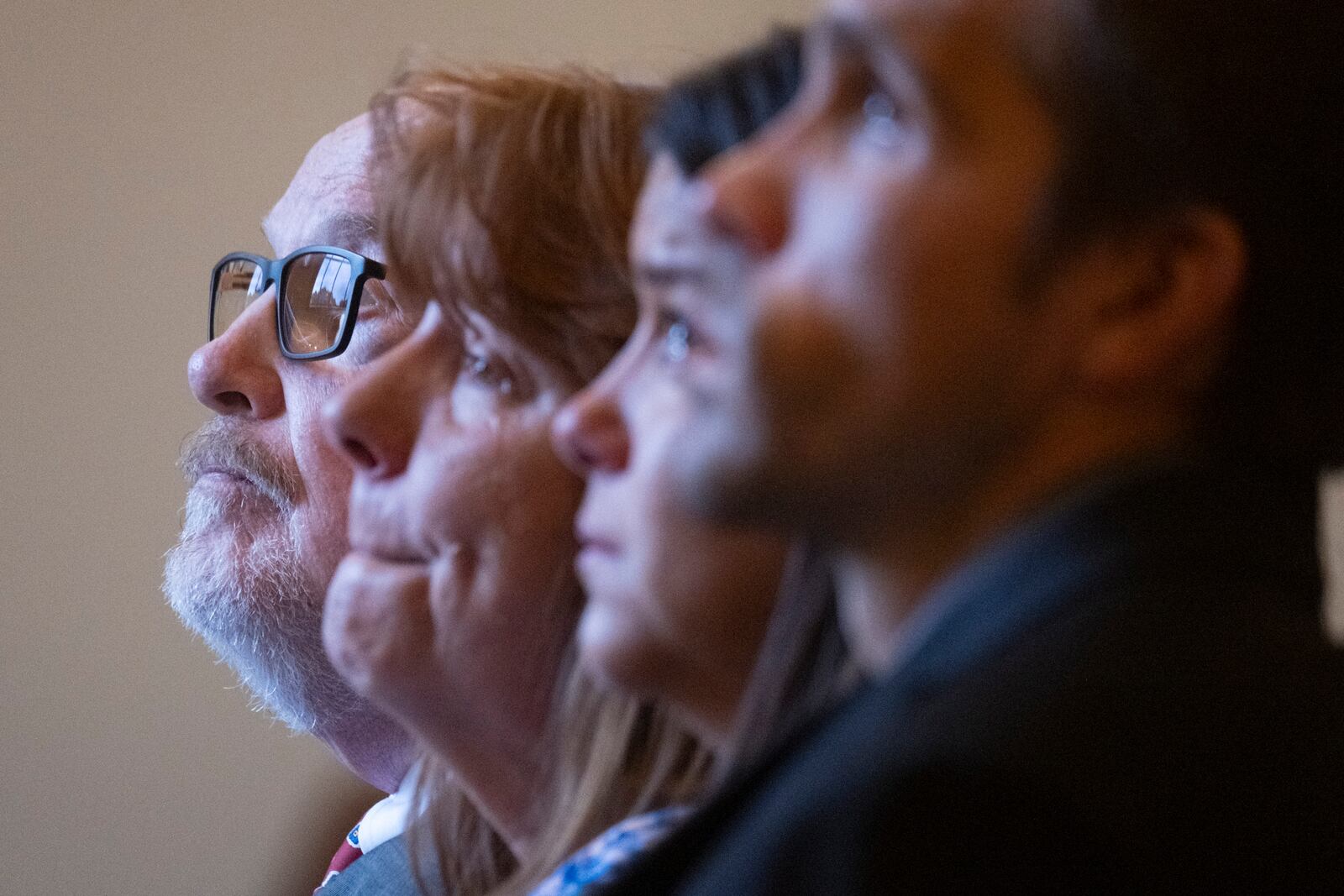 Michael McCullar sits with grieving family members during a funeral service for Jonathan Erik Locke in Peachtree Corners. McCullar officiates funerals in which he pays tribute to people he never knew when they were alive. (Ben Gray for the AJC)