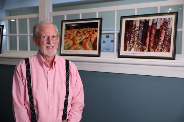 Graham Kerr, retired from the State Department, is shown with photographs he’s taken at a nearby farm recently. JASON GETZ / SPECIAL TO THE AJC