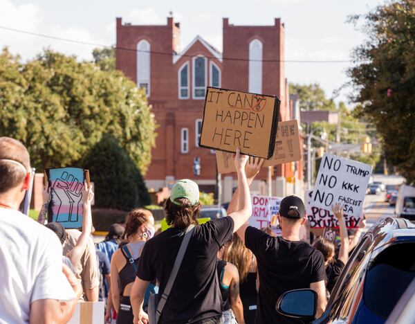 Protesters march past Ebenezer Baptist Church and toward the CNN Center on Saturday, Sept. 5, 2020.  The protest started at Ebenezer Baptist Church as a political gathering and joined a Black Lives Matter protest at the CNN Center with a heavy police escort along the way. (Jenni Girtman for The Atlanta Journal-Constitution)