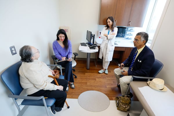 Patient at Georgia Memory Net Clinic at Grady Memorial Hospital. Beatriz Patiño (left) gets assistance from Dania Naser (second left) and Dr. Gabriela Cohen as they work on a cognitive assessment as her husband Jairo Patiño looks on Monday, Nov. 20, 2023. 
Miguel Martinez /miguel.martinezjimenez@ajc.com