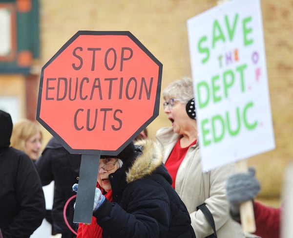 Dozens of people gather in downtown Niles, Mich., Thursday, March 20, 2025, to protest recent government cuts in the Department of Education. (Don Campbell/The Herald-Palladium via AP)