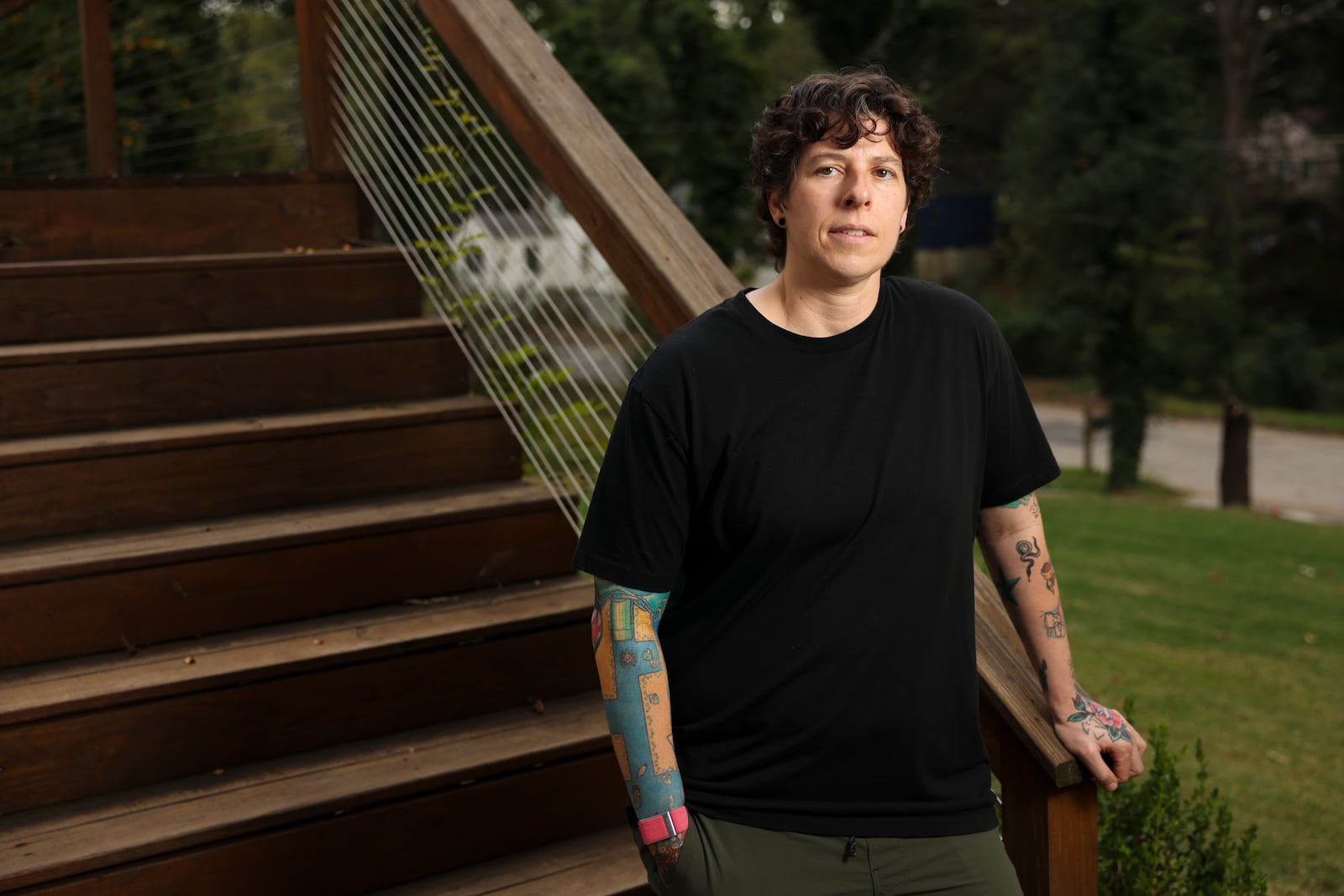 Carrie Dufresne, a camera operator, is shown on the porch of her home, Friday, Oct. 4, 2024, in Atlanta. Dufresne is one of thousands of metro Atlanta film industry professionals impacted by a slowdown of production across the country. (Jason Getz / AJC)

