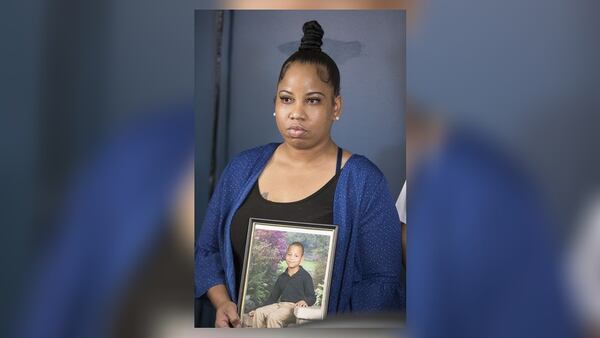 Allison Woods holds a photo of her son Isaiah Payton. 