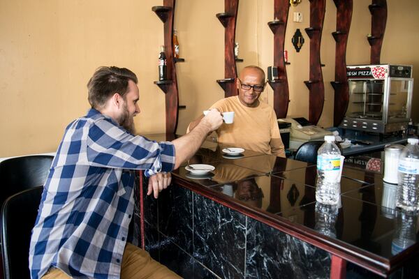 Clarkston Mayor Ted Terry and Abyssinia Café owner Alex Tsegaye share coffee. Tsegaye, an Ethiopian immigrant, has owned the cafe in Clarkston for 10 years. Terry said, “We have more than 13,000 people living in a 1.4-square-mile area, from dozens of countries.” CONTRIBUTED BY MIA YAKEL